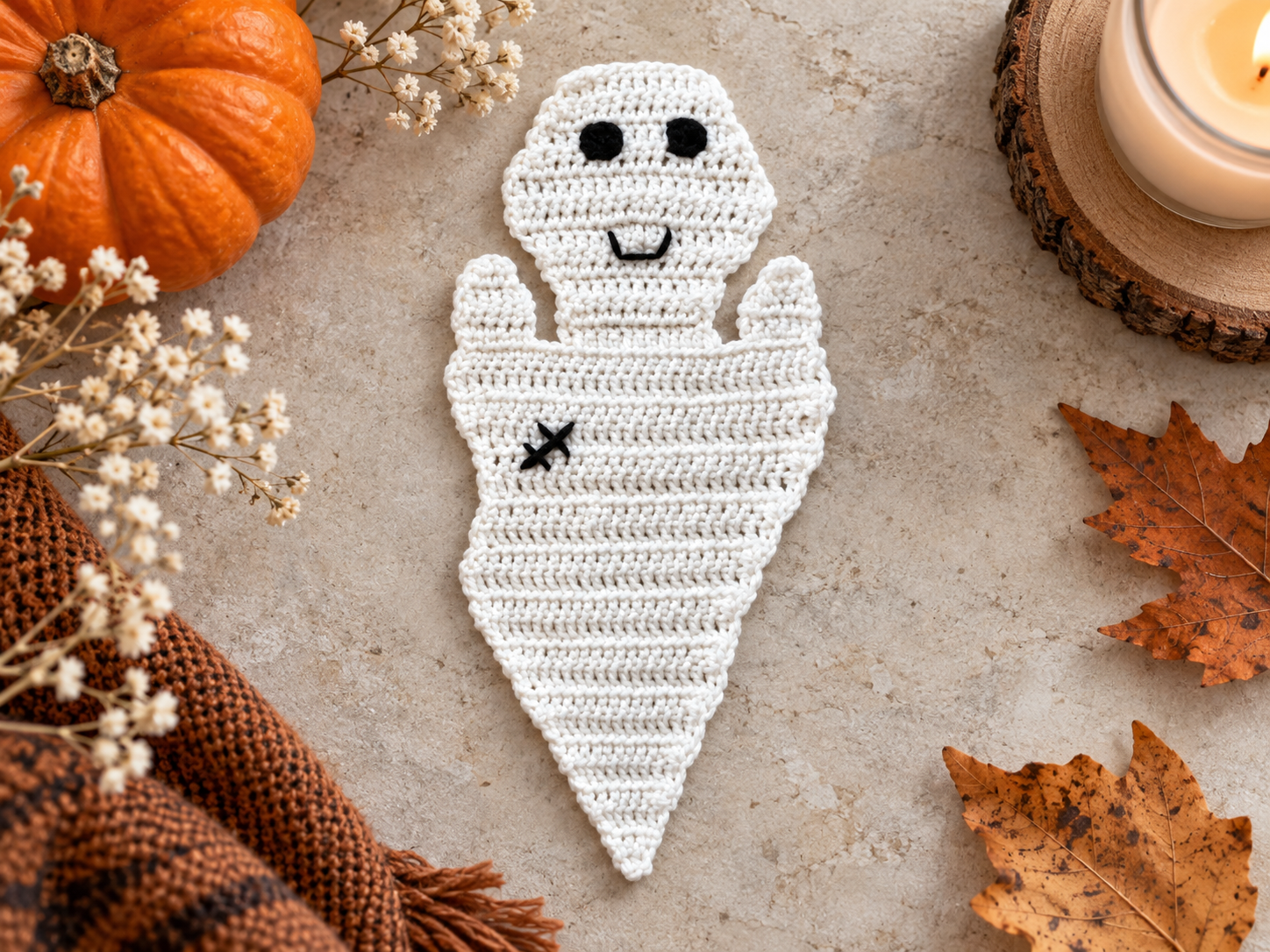 White crochet Halloween ghost applique styled with autumn decor