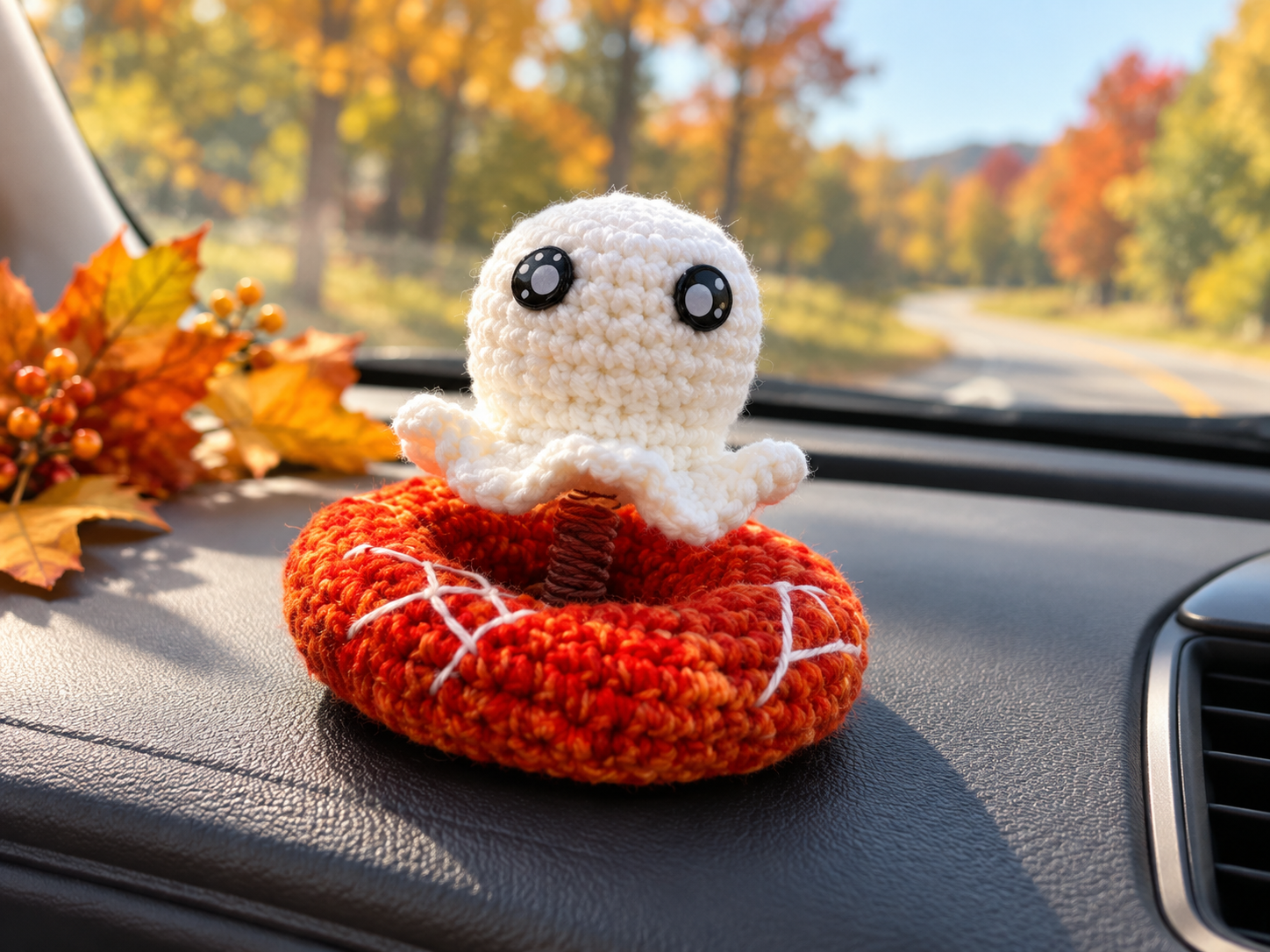 Halloween ghost car dashboard crochet pattern with a small white ghost on a red base